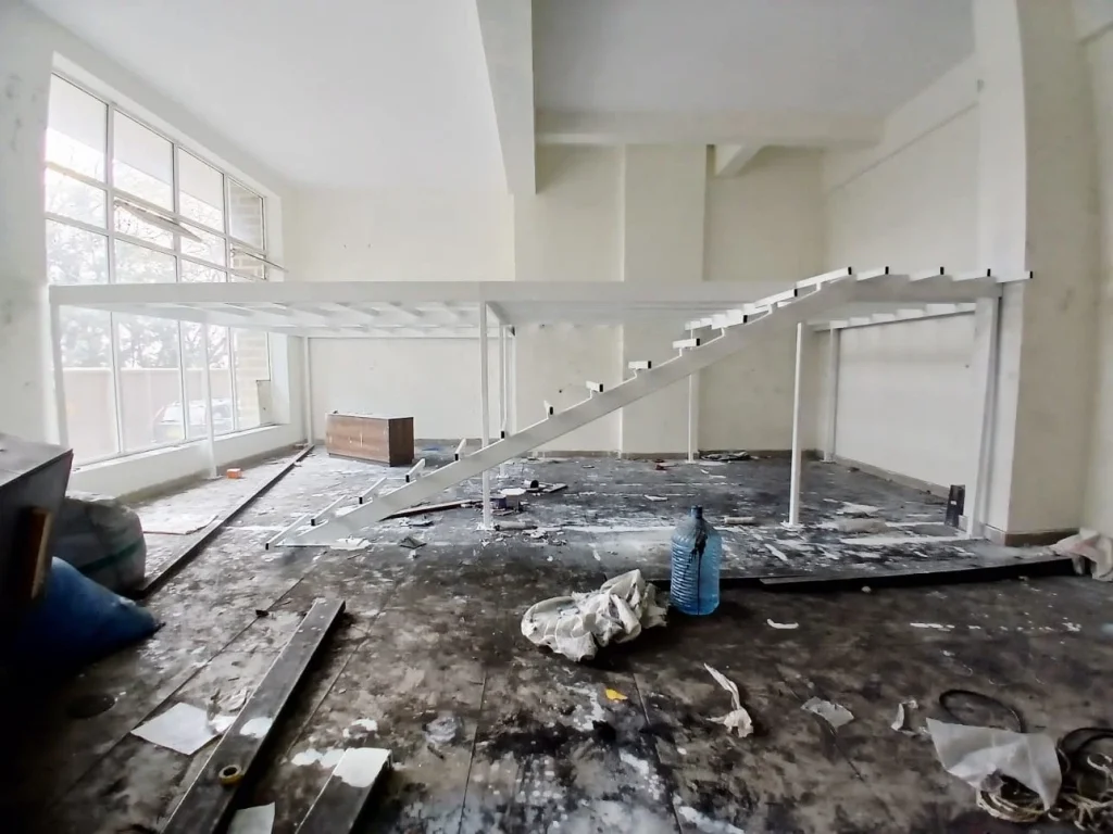 Steel mezzanine floor structure with steel staircase installed inside an existing building in Mombasa, Kenya, supervised by Cadreatech.