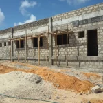 Completed low-rise hospital buildings at Xooga Hospital in Mogadishu, Somalia, showing external finishes, access paths, and ground preparation under civil and structural engineering supervision.